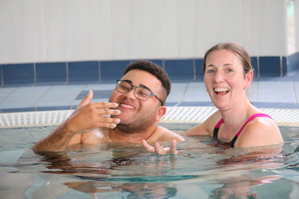 Learner and staff in hydro pool